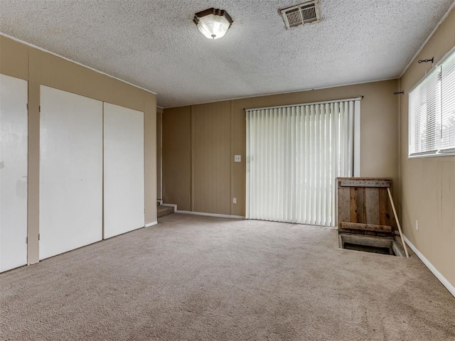 4113 Clendon Way, Del City, OK 73115 - unfurnished bedroom with carpet flooring, a closet, and a textured ceiling