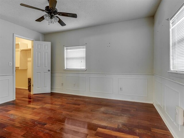 4113 Clendon Way, Del City, OK 73115 - spare room featuring wood finished floors, a ceiling fan, a decorative wall, a wainscoted wall, and a textured ceiling