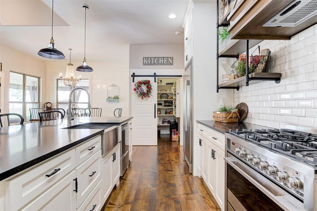 209 Pont Julienn Ct, Edmond, OK 73034 - kitchen with appliances with stainless steel finishes, dark countertops, white cabinets, and recessed lighting