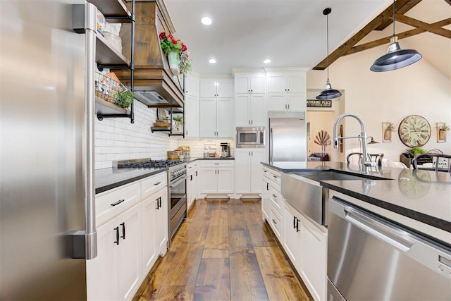 209 Pont Julienn Ct, Edmond, OK 73034 - kitchen with built in appliances, dark countertops, dark wood finished floors, tasteful backsplash, and pendant lighting