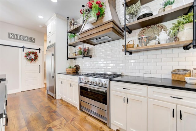 209 Pont Julienn Ct, Edmond, OK 73034 - kitchen with stainless steel appliances, open shelves, a barn door, premium range hood, and recessed lighting