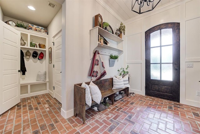 209 Pont Julienn Ct, Edmond, OK 73034 - mudroom featuring brick flooring, a chandelier, ornamental molding, and recessed lighting