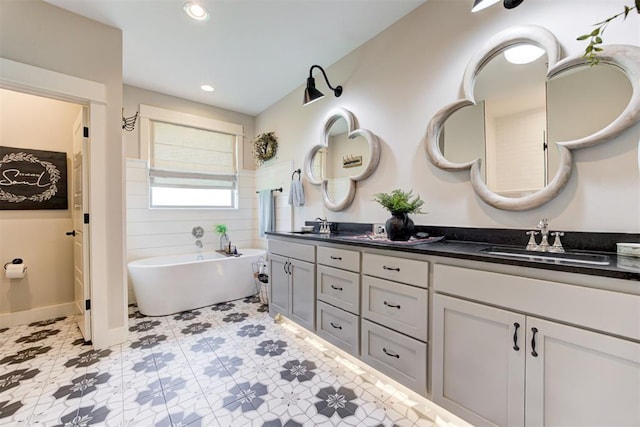 209 Pont Julienn Ct, Edmond, OK 73034 - bathroom with double vanity, a freestanding bath, and recessed lighting