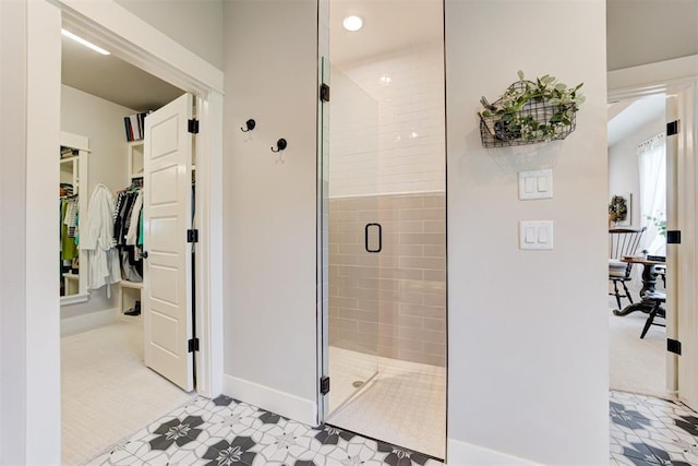 209 Pont Julienn Ct, Edmond, OK 73034 - full bath featuring a shower stall, a walk in closet, and tile patterned floors