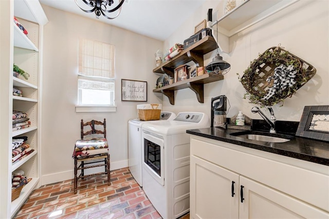 209 Pont Julienn Ct, Edmond, OK 73034 - washroom featuring washing machine and clothes dryer, brick floors, and cabinet space