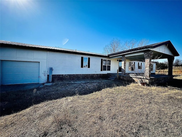 2099 County Road 1244, Tuttle, OK 73089 - back of property featuring an attached garage and covered porch