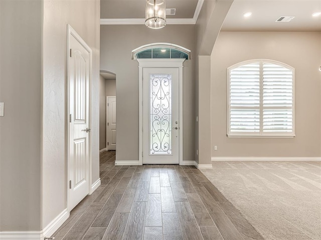 210 Bulverde Dr, Norman, OK 73069 - entrance foyer with wood finished floors, arched walkways, crown molding, and a chandelier