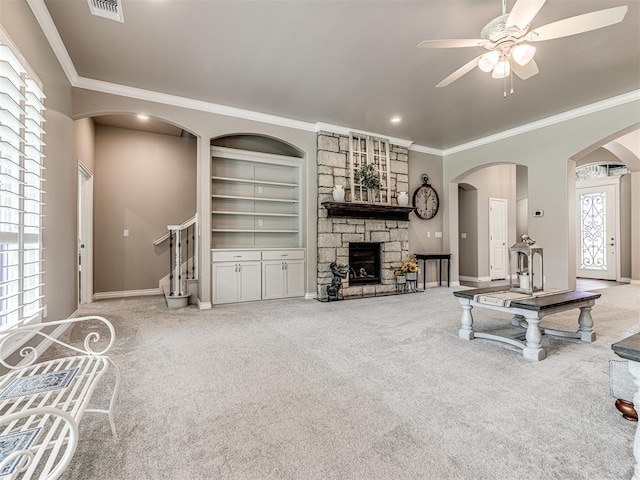 210 Bulverde Dr, Norman, OK 73069 - living area with crown molding, carpet, a ceiling fan, a fireplace, and stairway