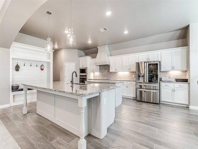 210 Bulverde Dr, Norman, OK 73069 - kitchen featuring appliances with stainless steel finishes, custom exhaust hood, tasteful backsplash, white cabinets, and recessed lighting