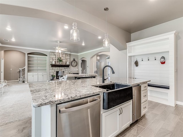 210 Bulverde Dr, Norman, OK 73069 - kitchen with stainless steel dishwasher, arched walkways, ceiling fan, open floor plan, and pendant lighting