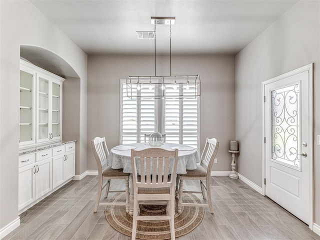 210 Bulverde Dr, Norman, OK 73069 - dining space featuring light wood-type flooring and arched walkways