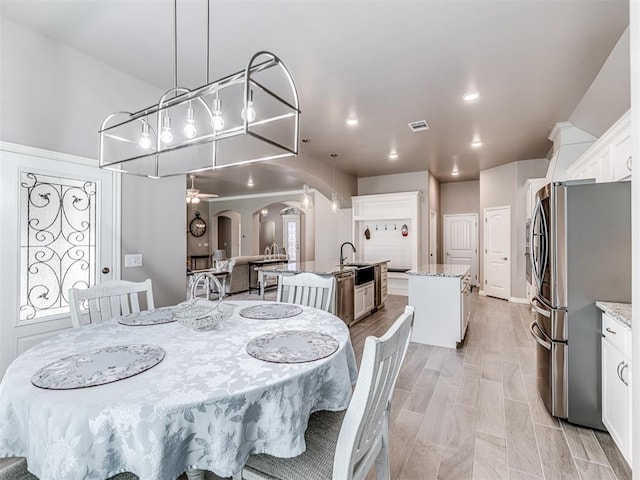210 Bulverde Dr, Norman, OK 73069 - dining room featuring arched walkways, a ceiling fan, and recessed lighting