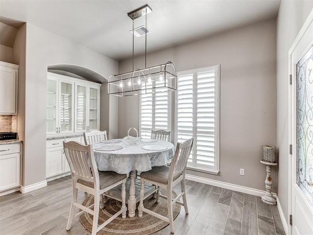 210 Bulverde Dr, Norman, OK 73069 - dining area featuring healthy amount of natural light, light wood finished floors, and a chandelier