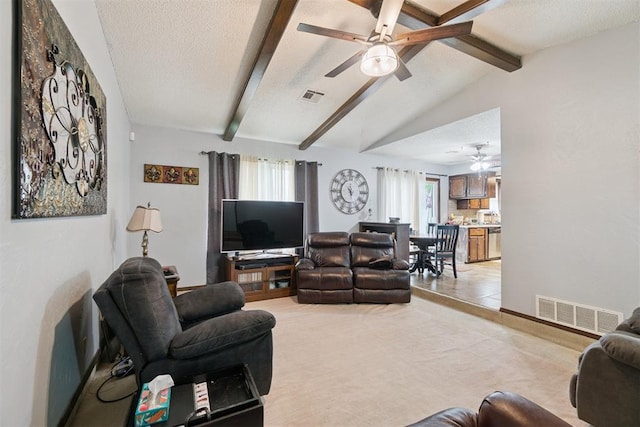 809 N Southminster St, Moore, OK 73160 - living room with a ceiling fan, a textured ceiling, and light colored carpet