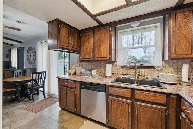 809 N Southminster St, Moore, OK 73160 - kitchen with stainless steel dishwasher, backsplash, and light countertops