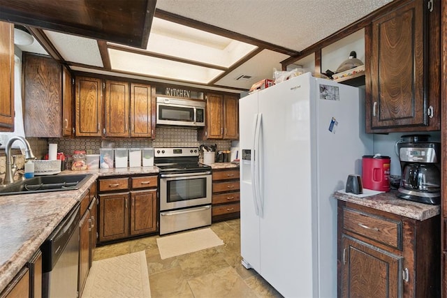 809 N Southminster St, Moore, OK 73160 - kitchen with appliances with stainless steel finishes, decorative backsplash, light countertops, and light stone finish flooring