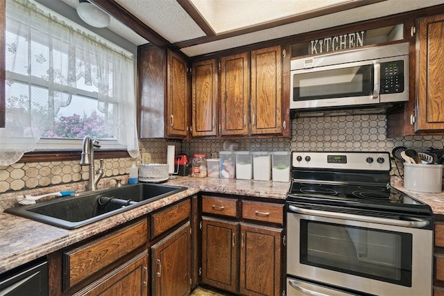 809 N Southminster St, Moore, OK 73160 - kitchen with stainless steel appliances, decorative backsplash, and light countertops