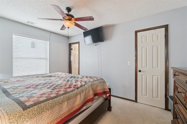 809 N Southminster St, Moore, OK 73160 - bedroom featuring light carpet, a textured ceiling, and a ceiling fan