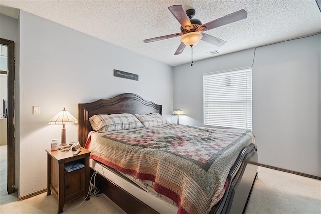 809 N Southminster St, Moore, OK 73160 - bedroom with light carpet, a textured ceiling, and ceiling fan