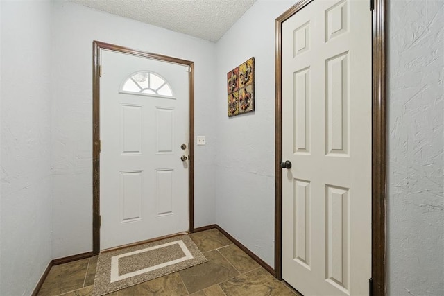 809 N Southminster St, Moore, OK 73160 - entryway featuring a textured ceiling and baseboards
