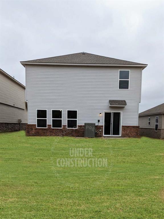 3629 Pete St, Yukon, OK 73064 - rear view of house with a lawn and brick siding
