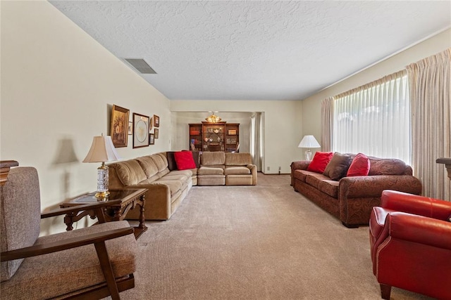 717 Maple St, Weatherford, OK 73096 - living area with light colored carpet and a textured ceiling
