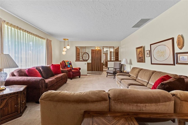 717 Maple St, Weatherford, OK 73096 - living room with light colored carpet and a textured ceiling