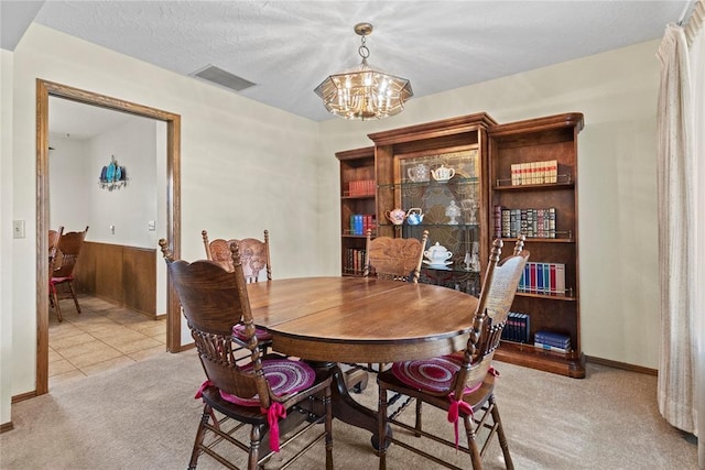 717 Maple St, Weatherford, OK 73096 - carpeted dining room with a chandelier and baseboards