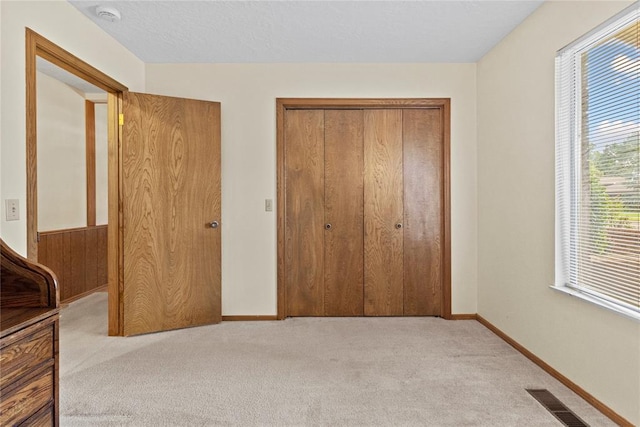 717 Maple St, Weatherford, OK 73096 - unfurnished bedroom featuring carpet and a closet
