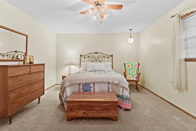 717 Maple St, Weatherford, OK 73096 - bedroom featuring carpet, a ceiling fan, and a textured ceiling
