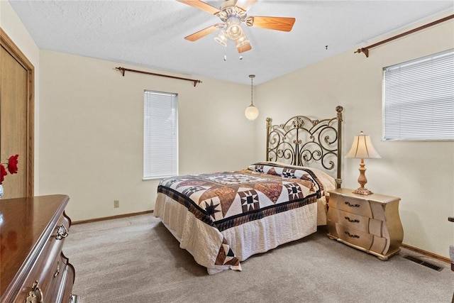 717 Maple St, Weatherford, OK 73096 - carpeted bedroom featuring baseboards and a ceiling fan