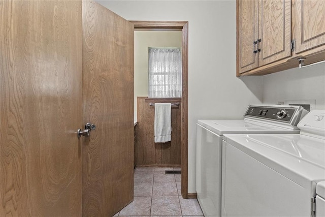 717 Maple St, Weatherford, OK 73096 - laundry room featuring independent washer and dryer, cabinet space, and light tile patterned flooring