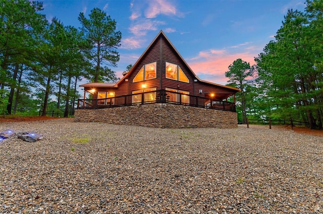 232 Orange Grove Rd, Broken Bow, OK 74728 - back of property at dusk featuring faux log siding