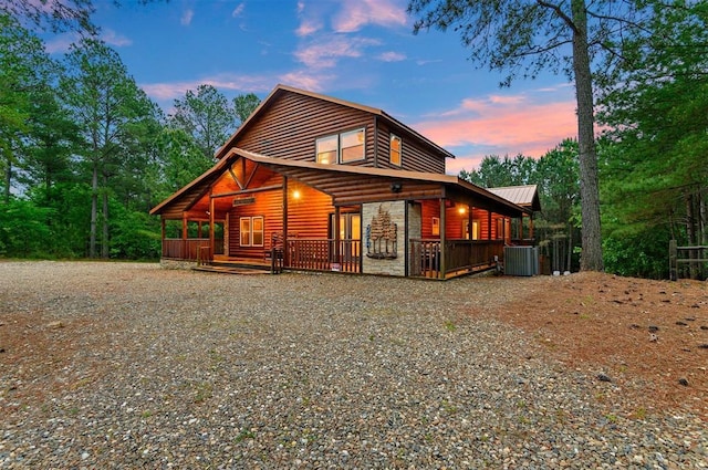 232 Orange Grove Rd, Broken Bow, OK 74728 - view of front of home with faux log siding, gravel driveway, and a metal roof