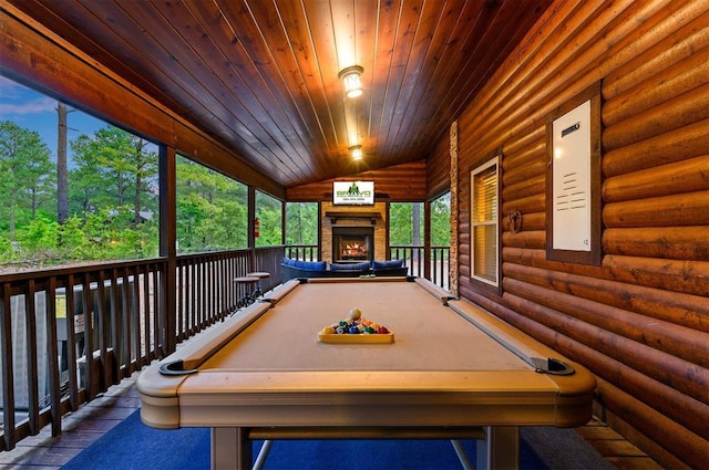 232 Orange Grove Rd, Broken Bow, OK 74728 - recreation room featuring rustic walls, wooden ceiling, a lit fireplace, and lofted ceiling