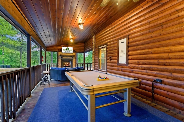 232 Orange Grove Rd, Broken Bow, OK 74728 - game room with wooden ceiling, hardwood / wood-style floors, rustic walls, pool table, and a warm lit fireplace
