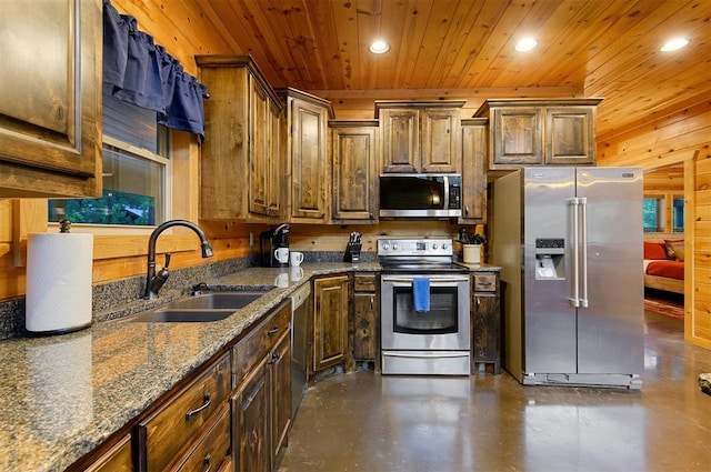 232 Orange Grove Rd, Broken Bow, OK 74728 - kitchen with stainless steel appliances, recessed lighting, wooden ceiling, concrete floors, and dark stone counters