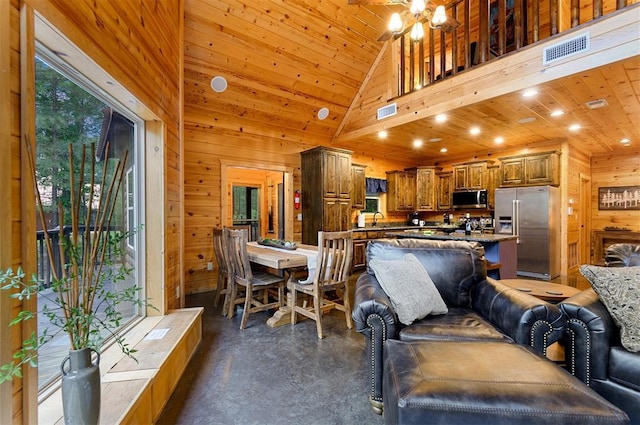 232 Orange Grove Rd, Broken Bow, OK 74728 - living area featuring wooden walls, finished concrete floors, recessed lighting, wooden ceiling, and a chandelier
