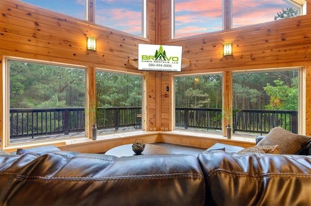 232 Orange Grove Rd, Broken Bow, OK 74728 - living room with wood walls and a wooded view