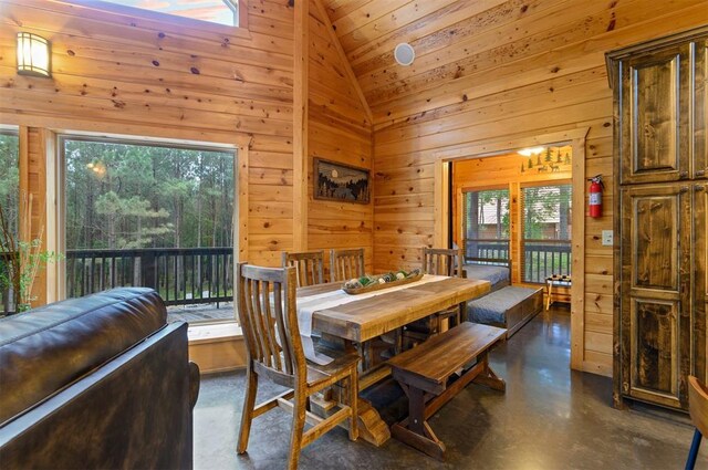 232 Orange Grove Rd, Broken Bow, OK 74728 - dining space featuring wood walls, lofted ceiling, finished concrete floors, and wood ceiling