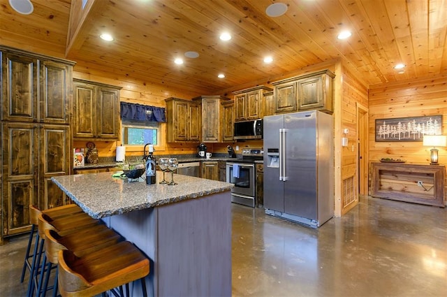232 Orange Grove Rd, Broken Bow, OK 74728 - kitchen featuring appliances with stainless steel finishes, concrete floors, recessed lighting, a kitchen island, and a kitchen bar