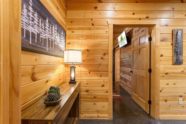 232 Orange Grove Rd, Broken Bow, OK 74728 - hallway featuring wooden walls and finished concrete flooring