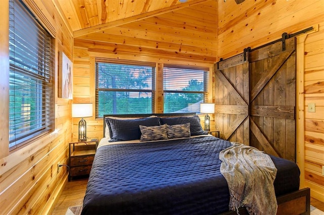 232 Orange Grove Rd, Broken Bow, OK 74728 - bedroom featuring wood walls, wood finished floors, a barn door, and wooden ceiling