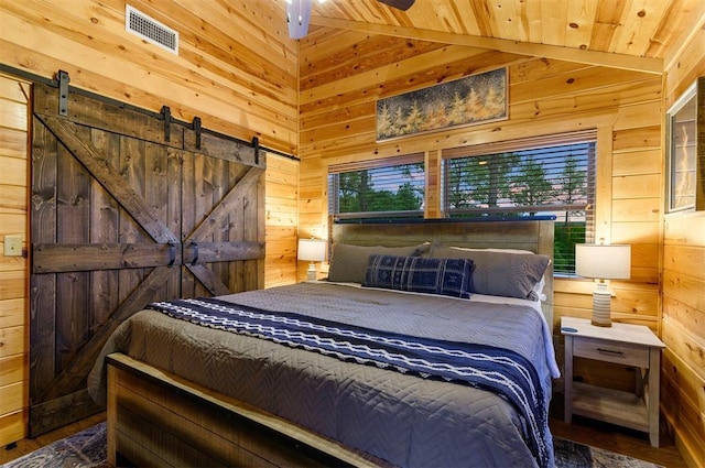 232 Orange Grove Rd, Broken Bow, OK 74728 - bedroom with wooden walls, wood ceiling, a barn door, lofted ceiling, and wood finished floors