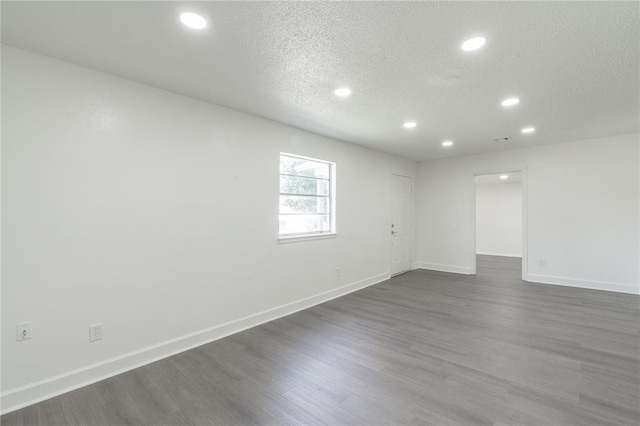 3916 S Youngs Pl, Oklahoma City, OK 73119 - unfurnished room with recessed lighting, a textured ceiling, and dark wood-style flooring