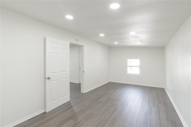 3916 S Youngs Pl, Oklahoma City, OK 73119 - spare room with dark wood-style flooring, recessed lighting, and a textured ceiling
