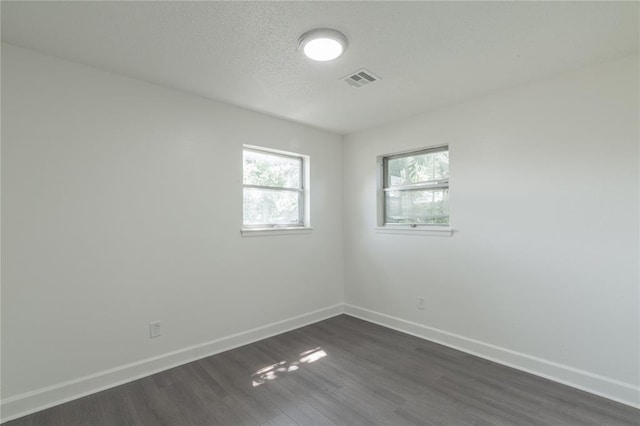 3916 S Youngs Pl, Oklahoma City, OK 73119 - spare room with dark wood-type flooring and a textured ceiling