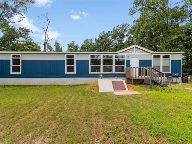back of property featuring a lawn and crawl space