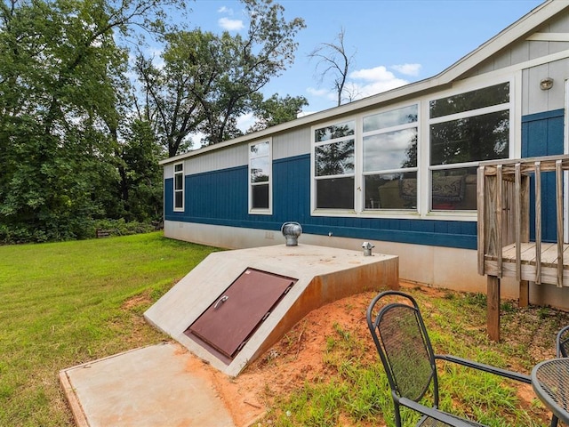 entry to storm shelter featuring a yard