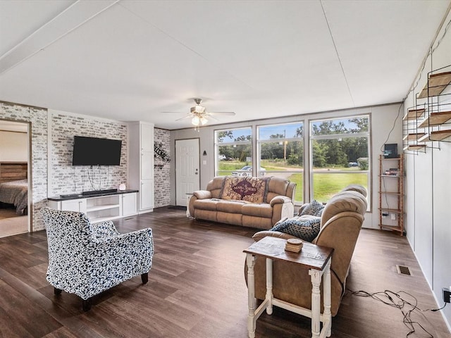 living area with dark wood-type flooring and a ceiling fan